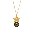 Gold star pendant necklace with a dark gemstone on a white background