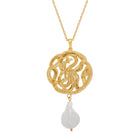 Gold necklace with a serpent pendant and pearl on a white background