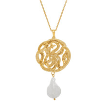 Gold necklace with a serpent pendant and pearl on a white background