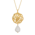 Gold necklace with a serpent pendant and pearl on a white background