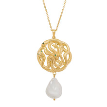 Gold necklace with a serpent pendant and pearl on a white background
