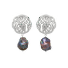 Pair of silver earrings with large black pearls on a white background