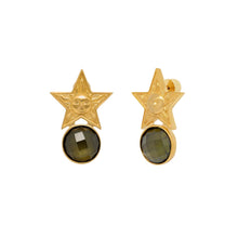 Gold star-shaped earrings with green gemstones on a white background