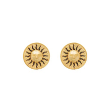 Gold sun stud earrings on ivoy background