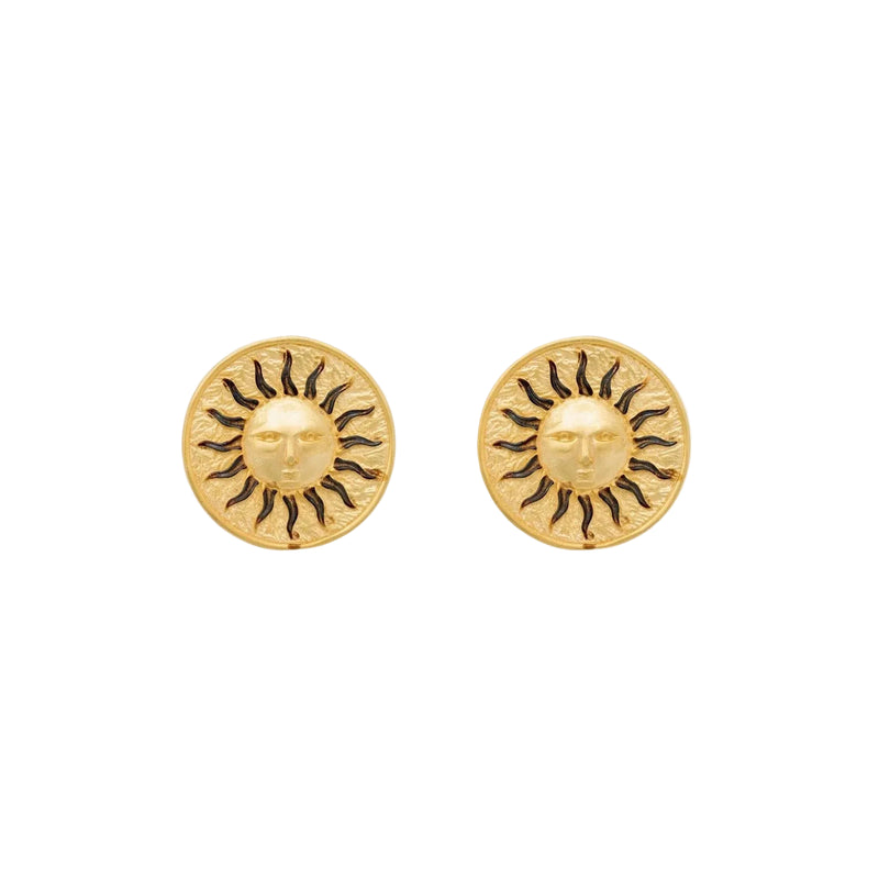 Gold sun stud earrings on ivoy background