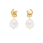 Gold serpent earrings with pearl drops on a white background