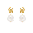 Gold serpent earrings with pearl drops on a white background