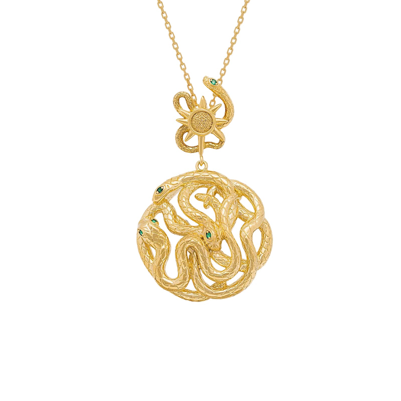 Gold necklace with a serpent pendant and star sun design on a white background