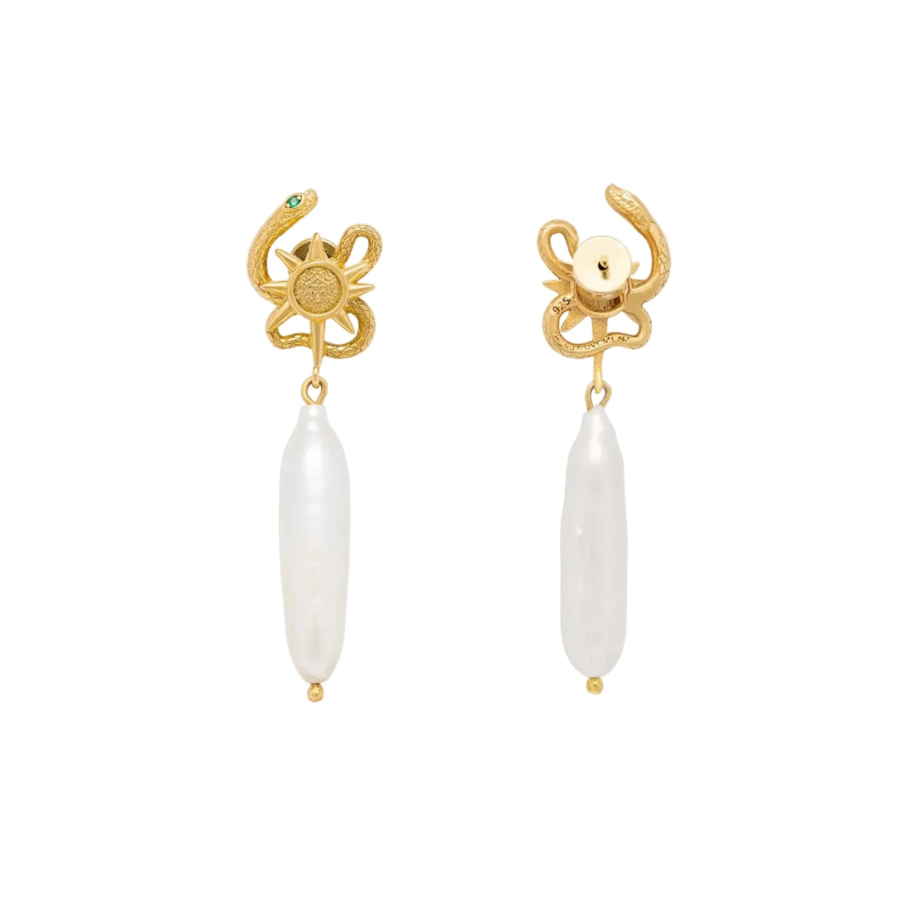Gold serpent shaped earrings with a pearl on a light beige background