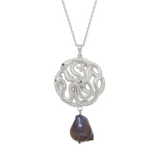 Silver necklace with a serpent pendant and a black pearl on a white background