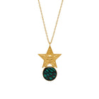 Gold necklace with star pendant and green gemstone on a white background