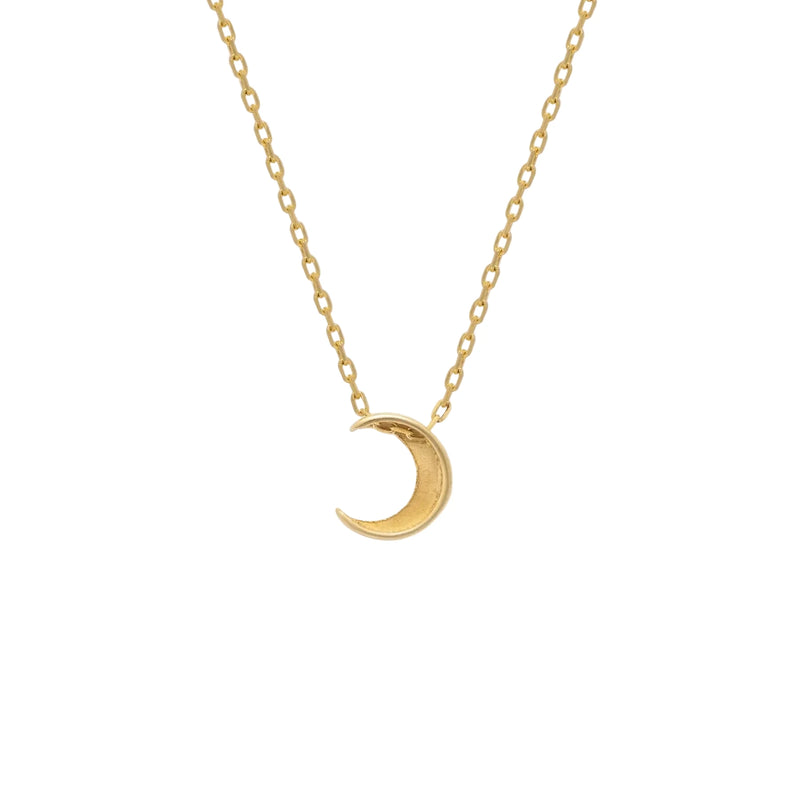 Gold crescent moon necklace on a white background