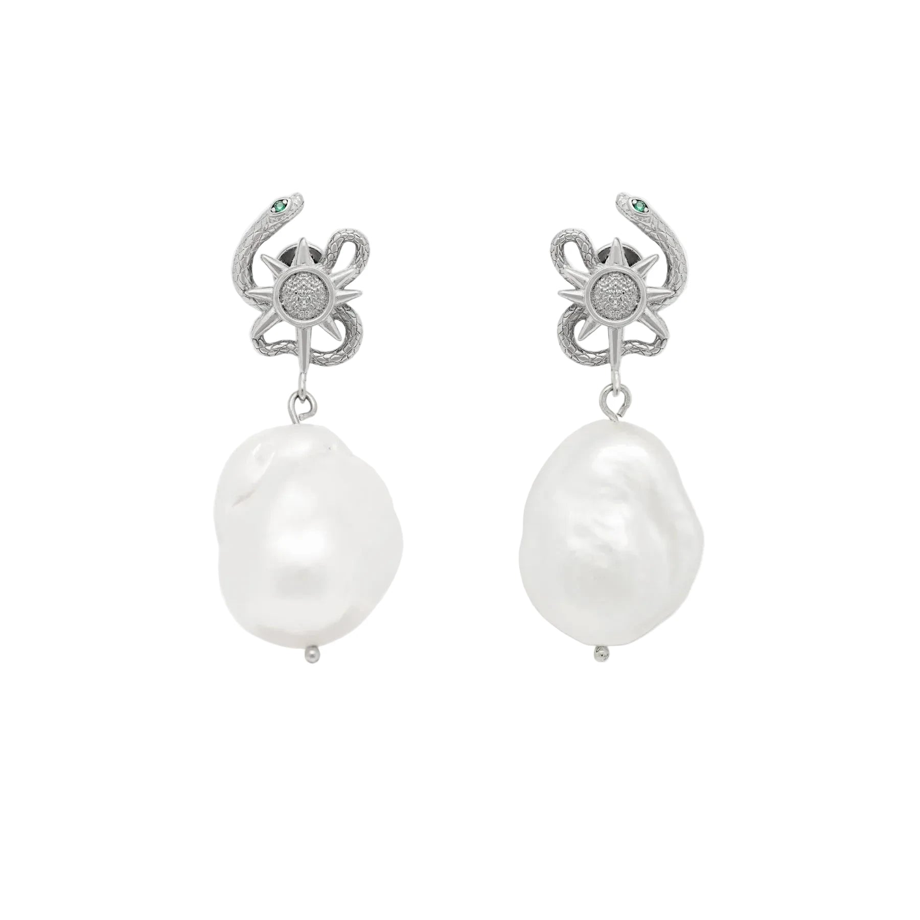 Pair of pearl earrings with silver serpent top on a white background