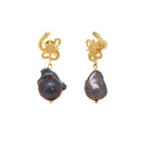 Pair of earrings with gold accents and dark pearls on a white background